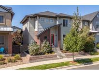 Modern two-story home with red door and brick accents at 6747 Raritan Dr, Denver, CO 80221
