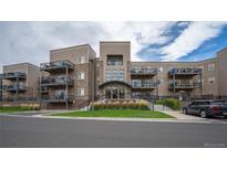 Exterior of an apartment building with multiple balconies and landscaping at 6000 W Floyd Ave # 107, Denver, CO 80227