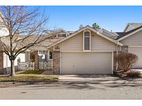 Charming two-story home with attached garage and white picket fence at 9312 Miles Dr, Lone Tree, CO 80124