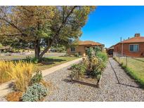 Ranch home with landscaped front yard at 3160 N Saint Paul St, Denver, CO 80205