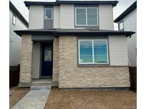 Two-story home with stone accents and a modern design at 21242 E 63Rd Dr, Aurora, CO 80019