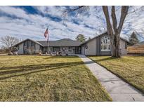 Gray ranch house with landscaped lawn and walkway at 7000 S Sheridan Blvd, Littleton, CO 80128