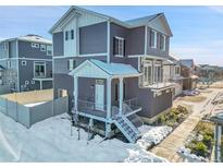 Modern two-story home with snow covered walkway at 4072 N Rome St, Aurora, CO 80019