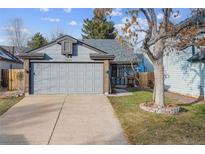 Ranch style home with attached garage and mature landscaping at 17935 E Bethany Dr, Aurora, CO 80013