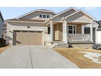 Ranch style home with a two-car garage and front porch at 39263 Clymer St, Elizabeth, CO 80107