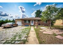 Brick ranch house with a paved driveway and fountain at 1493 S Yates St, Denver, CO 80219