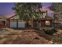 Brick house with attached two-car garage and landscaped front yard at 2577 S Eagle Cir, Aurora, CO 80014