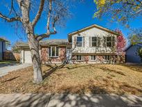 Brick ranch house with a well-maintained lawn at 17445 E Arkansas Ave, Aurora, CO 80017