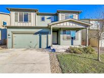 Two-story house with green exterior, two-car garage, and landscaping at 2012 Monte Vista Dr, Lochbuie, CO 80603