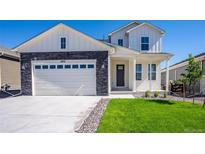 Two-story house with white siding, stone accents, and a two-car garage at 16031 Mountain Flax Dr, Monument, CO 80132