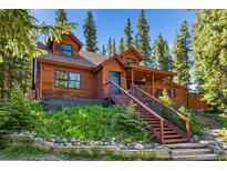 Rustic mountain home with wooden exterior and stairs at 654 County Road 672, Breckenridge, CO 80424