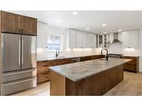 Modern kitchen with stainless steel appliances and large island at 824 W Geddes Cir, Littleton, CO 80120