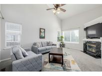 Bright living room featuring a fireplace, vaulted ceilings and neutral decor at 5748 S Zante Way, Aurora, CO 80015