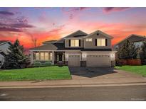 Two-story house with attached garage and landscaping at 7400 Iridium Way, Castle Rock, CO 80108