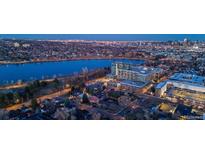 Night aerial view of a home near a lake and city skyline at 4200 W 17Th Ave # 338, Denver, CO 80204