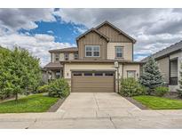 Two-story house with a two-car garage and landscaping at 9884 Eagle River St, Littleton, CO 80125