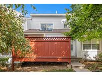 Charming townhome with white exterior and a red fence at 12242 Bannock Circle # B, Denver, CO 80234