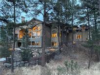 Luxury home with stone accents nestled in a wooded area at 662 Yankakee, Castle Rock, CO 80108