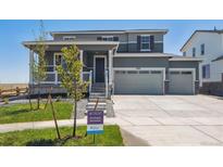 Two-story home with two-car garage and welcoming porch at 3362 N Highlands Creek Pkwy, Aurora, CO 80019