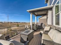 Back deck with seating area, fire pit, and built-in grill at 241 S Quantock St, Aurora, CO 80018