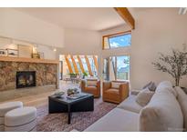 Spacious living room with stone fireplace and large windows at 225 Bristlecone Way, Boulder, CO 80304