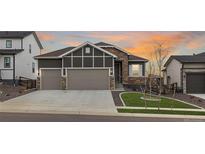 Two-story home with stone accents and a two-car garage at 12722 Cove St, Firestone, CO 80504