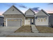 Stunning two-story home with gray siding and brick accents at 7322 Canyon Sky Trl, Castle Pines, CO 80108