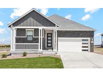 Modern craftsman style home with gray and white exterior, stone accents, and a two-car garage at 42962 Colonial Trl, Elizabeth, CO 80107