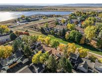 Aerial view of a townhome community nestled near a lake, showcasing fall foliage at 5374 W Canyon Trl # B, Littleton, CO 80128