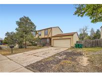 Two-story house with a two-car garage and a nicely landscaped front yard at 3906 S Pitkin Way, Aurora, CO 80013