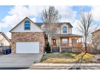 Inviting two-story home with a charming front porch and attached garage at 5884 Wood Duck Ct, Frederick, CO 80504