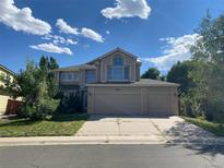 Two-story house with a three-car garage and a manicured lawn at 20420 Kelly Pl, Denver, CO 80249