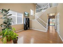 Bright living room with hardwood floors, high ceilings, and large windows at 33 Gaviota Ave, Brighton, CO 80601