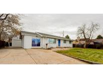 Charming single-story home with white brick exterior, blue door, and attached garage at 234 Lansing St, Aurora, CO 80010