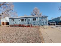 Ranch style home with a spacious yard and attached garage at 4020 Newman St, Wheat Ridge, CO 80033