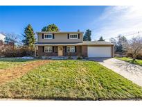 Brick ranch home with attached garage and landscaped yard at 6996 S Cook Way, Centennial, CO 80122