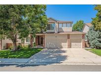 Two-story house with a three-car garage and well-maintained lawn at 10185 Silver Maple Cir, Highlands Ranch, CO 80129