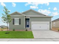 Green house exterior with 2-car garage at 2144 Alyssa St, Fort Lupton, CO 80621