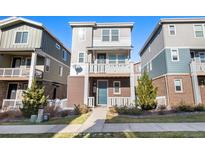 Brick front elevation of a two-story townhome with a small front yard at 12712 E Caspian Pl, Aurora, CO 80014