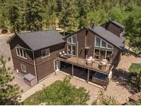 Aerial view of two-story home with deck and hot tub at 12171 S Critchell Ln, Littleton, CO 80127