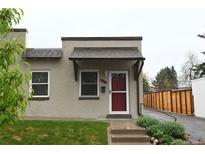 Charming stucco home with red door and steps leading to the entrance at 2660 Utica St, Denver, CO 80212