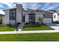 Modern home exterior with stone accents and landscaped lawn at 7125 Skygazer St, Castle Pines, CO 80108