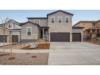 Two-story home with gray siding and stone accents at 3452 N Gold Bug Ct, Aurora, CO 80019