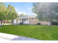 Ranch style home with well-manicured lawn and driveway at 2866 E Euclid Pl, Centennial, CO 80121