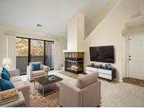 Bright living room with fireplace and access to balcony at 3600 S Pierce St # 5-204, Denver, CO 80235