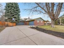 Ranch home with two-car garage and landscaped yard at 6765 S Adams Way, Centennial, CO 80122