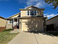 Two-story house with beige siding and brick accents at 19093 E Bellewood Dr, Aurora, CO 80015