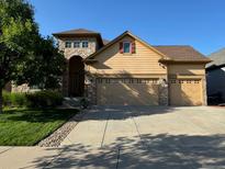 Two-story house with three-car garage and landscaped lawn at 22731 Hopewell Ave, Parker, CO 80138