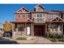 Two-story townhome with a red brick facade and a front porch at 818 S Terry St # 85, Longmont, CO 80501