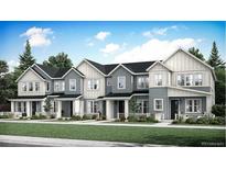 Modern townhome community with gray siding and white trim at 708 N Bently St, Watkins, CO 80137